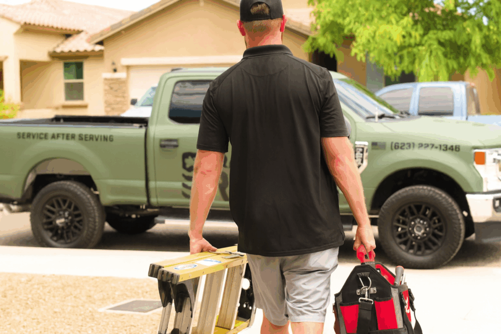 Garage Door Grunts technician heading to a service call with tools