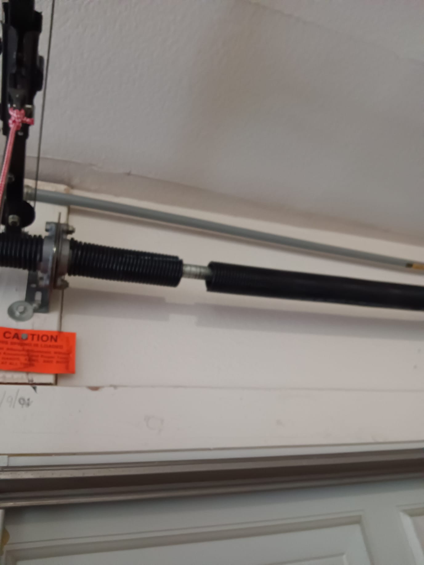 A broken garage door spring.
