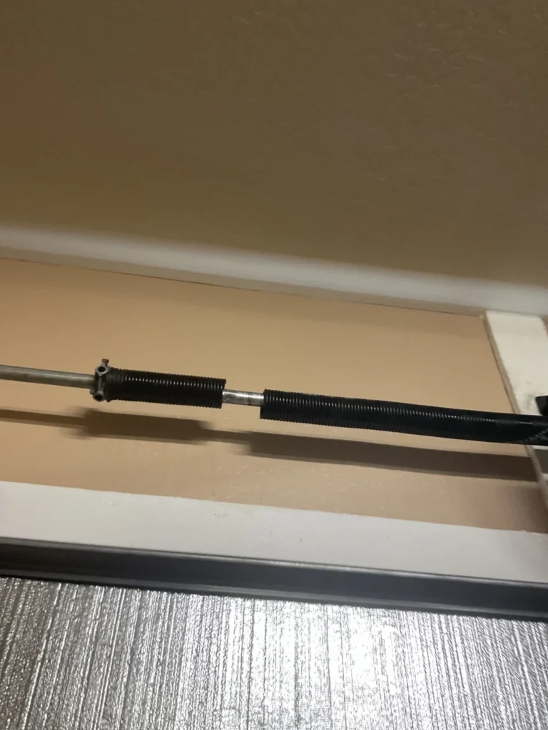 Garage Door Spring was broken - Springs were overworked - IPPT was off due to the added weight of the insulation. Improper springs for the weight of the door caused this spring to break