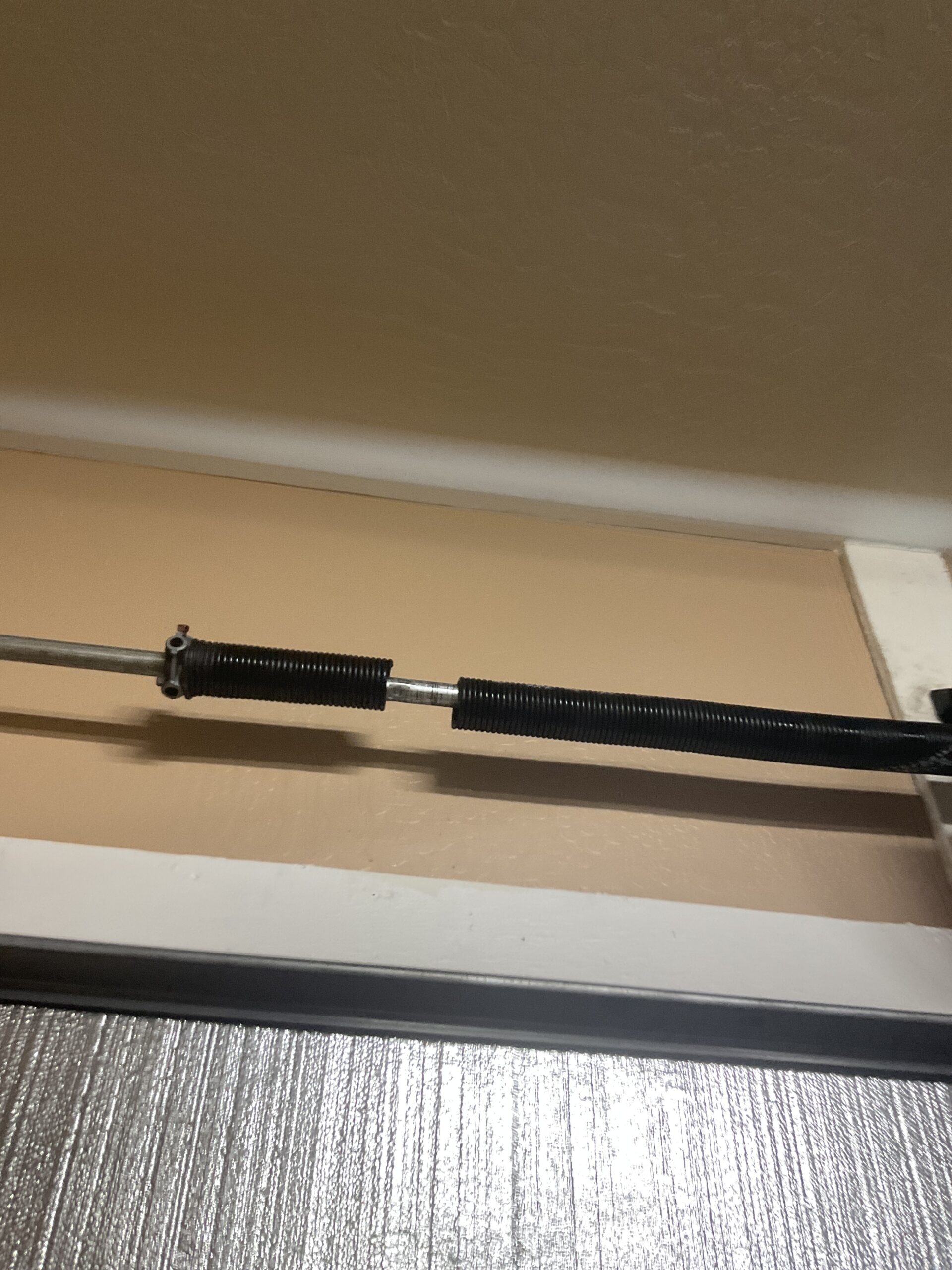Garage Door Spring was broken - Springs were overworked - IPPT was off due to the added weight of the insulation. Improper springs for the weight of the door caused this spring to break
