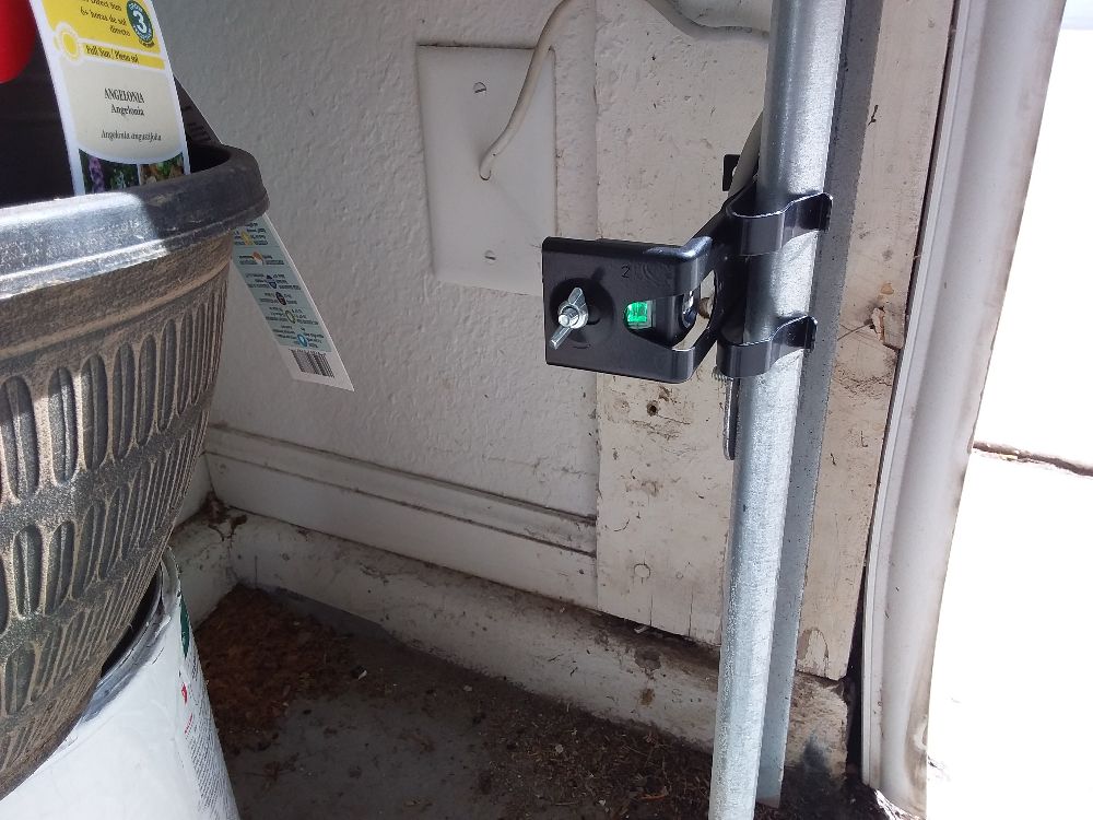 LiftMaster garage door safety sensor mounted near the floor track