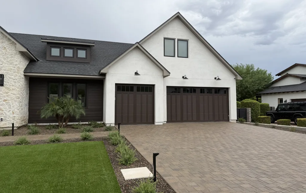Carriage-style garage doors with vertical slats and long-panel windows in Arcadia, AZ