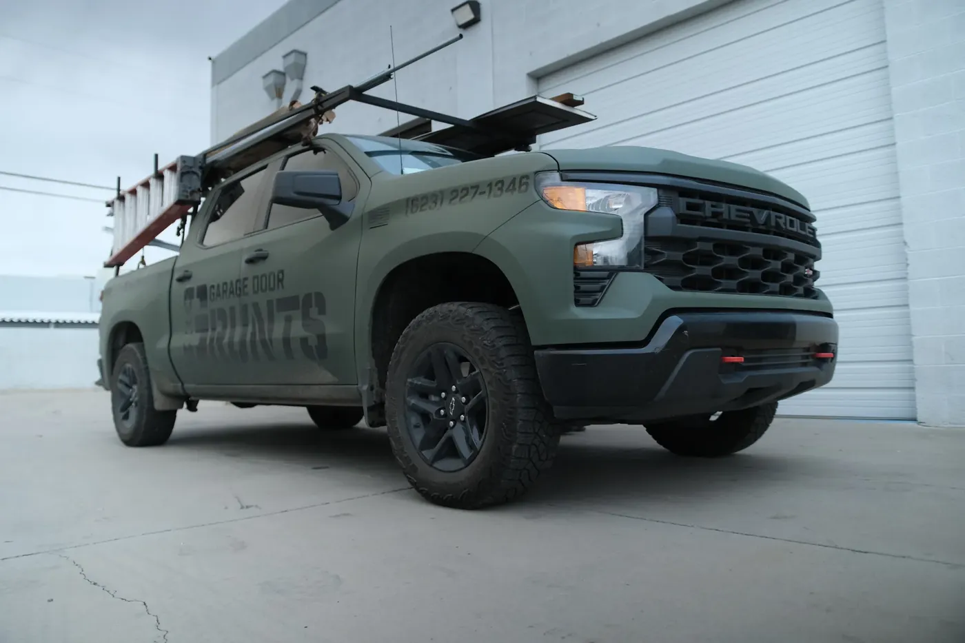 Garage Door Grunts service truck outside our shop